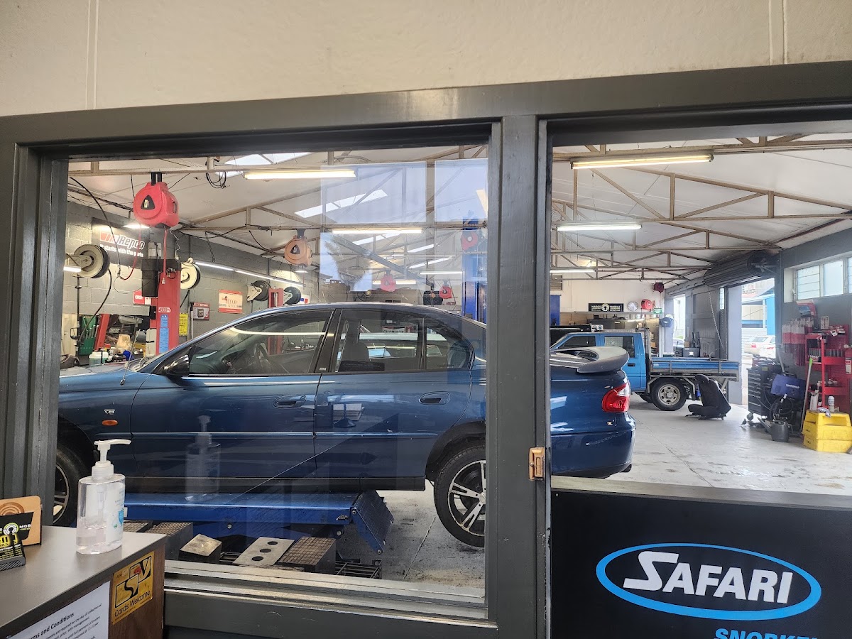 View into the workshop from reception, cars on hoists